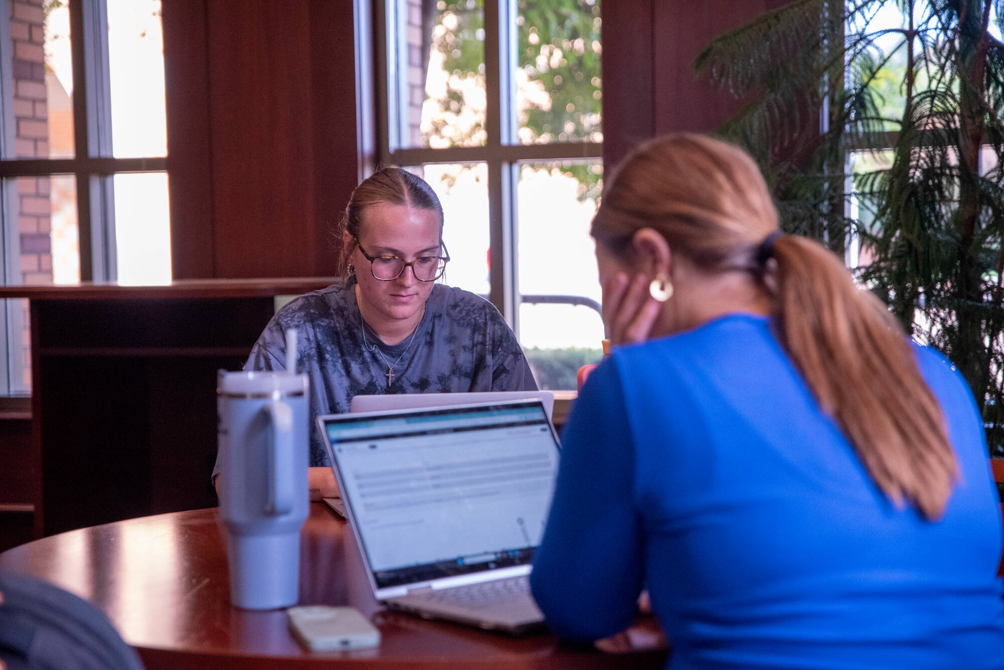 Madison Ingle, a Junior, works on her upcoming Pop Culture assignment in the Steelcase Library on September 10.Photo release on file
